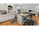 Modern kitchen features stainless appliances, white cabinets, a center island, and easy access to dining, and living areas at 730 Glenferry Trl, Atlanta, GA 30328