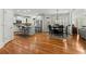 Modern kitchen with stainless steel appliances, white cabinetry, a center island, and an adjacent dining area at 730 Glenferry Trl, Atlanta, GA 30328