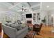 Bright living room with a cozy fireplace, built-in bookshelves, and a large window overlooking the backyard at 730 Glenferry Trl, Atlanta, GA 30328