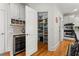 Walk-in pantry featuring ample shelving for organized storage, a beverage cooler and seamless access to the kitchen at 730 Glenferry Trl, Atlanta, GA 30328