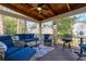 Relaxing screened porch with comfortable seating, ceiling fan, and a view of the private backyard at 730 Glenferry Trl, Atlanta, GA 30328