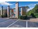 Exterior view of the townhome, featuring a neat and landscaped front yard and ample parking at 1115 Riverbend Club Se Dr, Atlanta, GA 30339