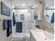 Renovated bathroom with new fixtures, custom shower, and a glass door at 1115 Riverbend Club Se Dr, Atlanta, GA 30339