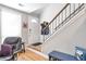 Welcoming entryway featuring hardwood floors, a coat rack, and easy access to the staircase at 1115 Riverbend Club Se Dr, Atlanta, GA 30339