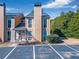 Charming home exterior with a well-maintained lawn, parking spaces, and a view of the surrounding greenery at 1115 Riverbend Club Se Dr, Atlanta, GA 30339