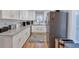 Well-lit kitchen with stainless steel appliances, white cabinets, and modern countertops at 1115 Riverbend Club Se Dr, Atlanta, GA 30339