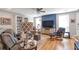 Comfortable living room featuring hardwood floors, built-in shelves, and modern decor at 1115 Riverbend Club Se Dr, Atlanta, GA 30339