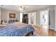 Spacious bedroom features wood laminate floors, ceiling fan and an adjacent bathroom at 1115 Riverbend Club Se Dr, Atlanta, GA 30339