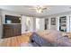 Spacious main bedroom with a ceiling fan, a view of a dressing room, and an ensuite bathroom at 1115 Riverbend Club Se Dr, Atlanta, GA 30339