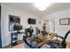 Functional home office area with desk, shelving, and television for work and entertainment at 1115 Riverbend Club Se Dr, Atlanta, GA 30339