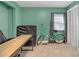 Green bedroom with a light-colored wood desk, bicycle and neutral carpet at 1146 Sims Sw St, Atlanta, GA 30310