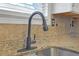 Close-up of a kitchen sink with a modern faucet and granite countertop at 1146 Sims Sw St, Atlanta, GA 30310