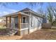 Rear exterior featuring charming covered porch, well-maintained siding and steps that lead to the cozy backyard at 1146 Sims Sw St, Atlanta, GA 30310