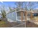 Charming home exterior featuring a cozy covered porch, a secure fence, and freshly painted siding at 1146 Sims Sw St, Atlanta, GA 30310
