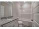Well-lit bathroom with a granite countertop vanity, a shower-tub combo, and white trim at 121 Sunflower Cir, Cartersville, GA 30121