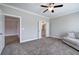Bedroom with carpet, ceiling fan, and doorways to the hallway and bathroom at 121 Sunflower Cir, Cartersville, GA 30121