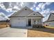 Charming single-Gathering home with a two-car garage, stone accents, and landscaped front yard at 121 Sunflower Cir, Cartersville, GA 30121