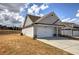 A view of a charming single-story home with a long driveway and manicured lawn at 121 Sunflower Cir, Cartersville, GA 30121