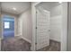 Hallway leading to walk-in closet, carpet and natural light, offering practical storage at 121 Sunflower Cir, Cartersville, GA 30121