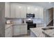 Bright kitchen features white cabinets, stainless steel microwave and oven, and granite countertops at 121 Sunflower Cir, Cartersville, GA 30121