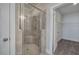 Bathroom shower featuring a glass enclosure, tile surround, bench and showerhead at 121 Sunflower Cir, Cartersville, GA 30121