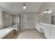 Bathroom featuring a soaking tub, glass shower, double sink vanity, and tile floor at 2856 Captain Ct, Dacula, GA 30019