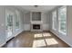 Cozy living room with fireplace and built-in shelving, filled with natural light at 2856 Captain Ct, Dacula, GA 30019