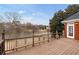 Large deck overlooking tranquil lake, providing a serene outdoor living space with ornamental railings at 426 Lakestone Dr, Suwanee, GA 30024