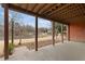 Covered patio with sturdy pillars offering serene lake views, perfect for outdoor relaxation and entertaining at 426 Lakestone Dr, Suwanee, GA 30024