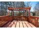 Deck with pergola offering a relaxing outdoor space surrounded by mature trees at 475 Cascade Rise Sw Ct, Atlanta, GA 30331