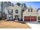 Charming two-story home with a landscaped front yard and attached garage at 475 Cascade Rise Sw Ct, Atlanta, GA 30331