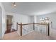Bright landing featuring wooden railing and large window, creating an inviting transition between floors at 475 Cascade Rise Sw Ct, Atlanta, GA 30331