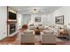 Bright living room features a fireplace, wood floors, and comfortable seating arrangements at 475 Cascade Rise Sw Ct, Atlanta, GA 30331
