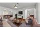 Cozy living room featuring hardwood floors, neutral furniture, and an open archway to the staircase at 475 Cascade Rise Sw Ct, Atlanta, GA 30331