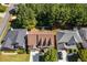 An aerial view shows a neighborhood home with manicured lawns and mature trees, blending suburban living with natural beauty at 730 Pear Grove Pl, Marietta, GA 30066