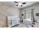 Bright Bedroom featuring modern crib, patterned accent wall, and stylish decor at 730 Pear Grove Pl, Marietta, GA 30066