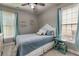 Cozy bedroom features a ceiling fan, two windows and decor for Lake Allatoona and Lake Lanier at 730 Pear Grove Pl, Marietta, GA 30066