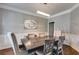 Formal dining room featuring elegant wainscoting, modern lighting, and a stylish table with seating for six at 730 Pear Grove Pl, Marietta, GA 30066