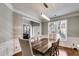 Bright dining room featuring hardwood floors, modern light fixture, and large windows for natural light at 730 Pear Grove Pl, Marietta, GA 30066