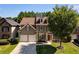Two-story home featuring a well-maintained lawn, a two-car garage, and a beautiful tree in the front yard at 730 Pear Grove Pl, Marietta, GA 30066