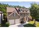 Lovely two-story home boasting three dormer windows, a two-car garage, and a well-kept front yard at 730 Pear Grove Pl, Marietta, GA 30066
