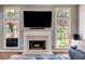 Cozy fireplace flanked by two large windows and an entertainment center, situated in the spacious living room at 730 Pear Grove Pl, Marietta, GA 30066