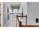 Upstairs hallway with wood banister overlooks the entry; neutral colors and light fixtures at 730 Pear Grove Pl, Marietta, GA 30066