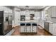 Stylish kitchen with granite island seating, stainless steel appliances, white cabinets, and hardwood flooring at 730 Pear Grove Pl, Marietta, GA 30066
