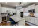 Well-lit kitchen with granite island, stainless steel appliances, white cabinetry, and a wine cooler at 730 Pear Grove Pl, Marietta, GA 30066