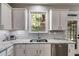 Bright kitchen featuring granite countertops, stainless steel appliances, and white subway tile backsplash at 730 Pear Grove Pl, Marietta, GA 30066