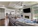 Open-concept living room with fireplace, built-ins, a view into the kitchen, and hardwood floors at 730 Pear Grove Pl, Marietta, GA 30066