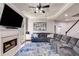 Comfortable living room featuring a fireplace, a large sectional sofa, and views to the backyard through large windows at 730 Pear Grove Pl, Marietta, GA 30066