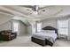 Large main bedroom offers a fan, tray ceiling and a sitting area with a leather chair at 730 Pear Grove Pl, Marietta, GA 30066