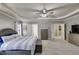 This main bedroom features a ceiling fan, windows and an ensuite bathroom at 730 Pear Grove Pl, Marietta, GA 30066